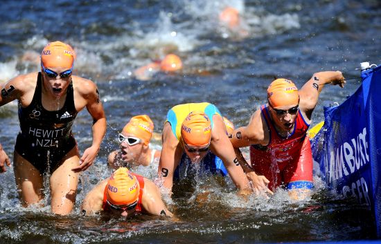 Andrea Hewitt (left) exits the swim on the first leg of the relay