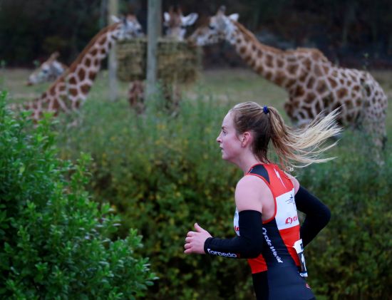 Rebecca Elliott running past the giraffes